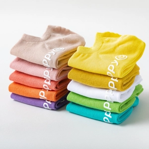 Macro detail of cotton low cut socks in various macaron colors with anti-slip silicone