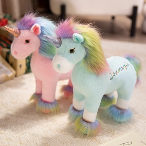 Pink and blue stuffed unicorn plush toys with rainbow manes and Courage embroidery