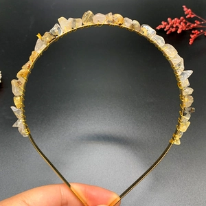 Detail of handcrafted yellow crystal stone crown with golden wire wrap on metal headband
