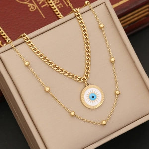 Double-layered gold stainless steel necklace featuring evil eye pendant and curb chain