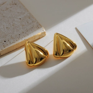 Vintage golden triangular earrings with sleek metallic finish on textured stone base