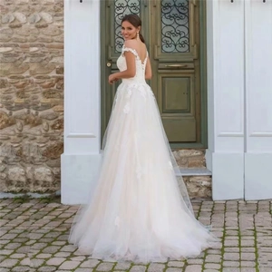Bohemian lace wedding dress with off-shoulder neckline and layered tulle floor-length skirt