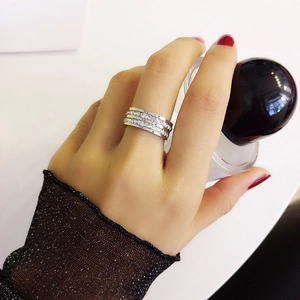 Close-up of a silver triple-layer ring with sparkling zircon stones on a model's hand