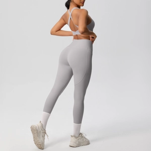 Macro shot of back cross-strap sports bra and high-waisted yoga leggings with side pockets
