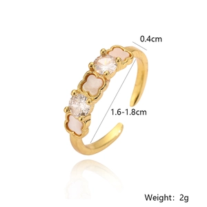 Detail view of gold geometric adjustable ring featuring clover motifs and cubic zirconia