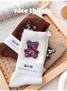 Detail of ribbed knit socks with sparkling rhinestone bear patches in assorted colors