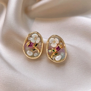 Vintage gold oval studs featuring purple roses, white flowers, and small pearls