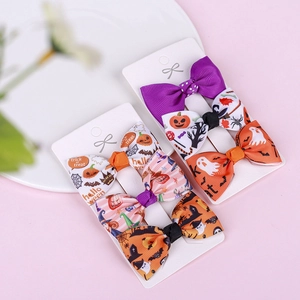 Detailed view of Halloween hair clips with pumpkin, ghost and bat patterns on ribbon