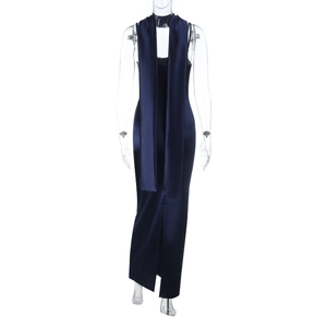 Detail of navy blue satin evening dress featuring a high back slit and silky texture