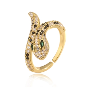 Adjustable gold snake ring with white and black zircons and green gemstone eyes
