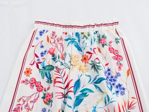 Detailed view of elastic waistband with red stripes and colorful floral print fabric