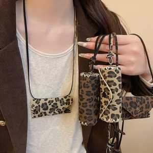 Detail of leopard print mini bag pendant with white hand-stitched seams and metal clasp