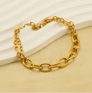 Detailed macro view of gold layered stainless steel chains with lobster clasp design