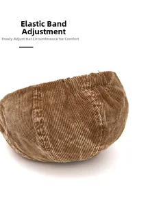 Close-up of the elastic adjustment band on the back of a brown corduroy newsboy cap