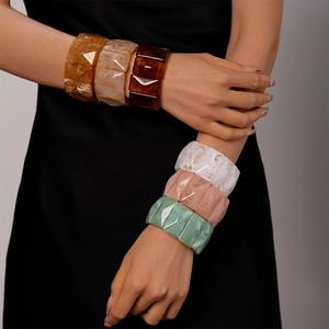 Retro geometric resin bangles with marble texture in amber and emerald tones