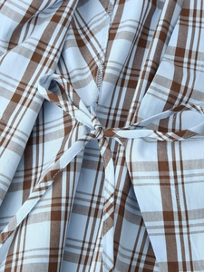 Detail of blue and brown checkered poplin shirt showing tie-up bow and stitching
