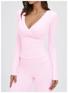 Front view of light pink V-neck yoga top and matching high-waisted fitness leggings
