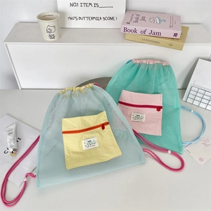 Detail showing breathable mesh drawstring backpacks in light blue and mint green colorways