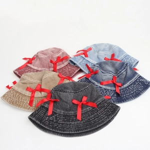 Detail of denim bucket hats with red satin bows in various vintage colors and fabric
