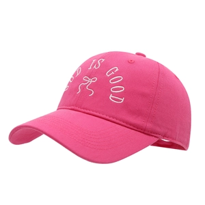 Hot pink baseball cap with GOD IS GOOD embroidery and white bow on soft cotton crown