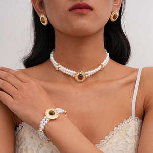 Close-up of vintage layered pearl necklace set with tiger eye stones and crystals