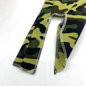 Detail of army green camouflage fabric with high-quality white overlock stitching seams