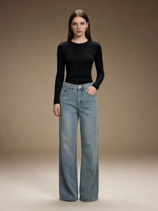 Women's blue high-waisted wide-leg jeans paired with a slim black long-sleeve top
