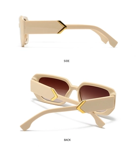 Detail view of beige square sunglasses with thick frames and golden arrow metal hinges