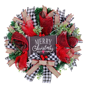 Christmas wreath with green needles red berries and black wood Merry Christmas sign