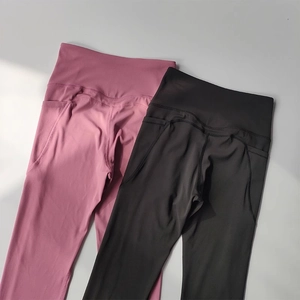 Detail of high-waisted yoga leggings with side pockets in dusty pink and charcoal black