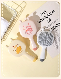 Detailed view of colorful cartoon hair brushes with soft cushion bristles and cute prints