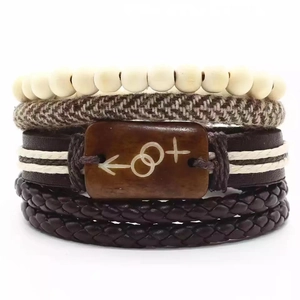 Détail d'un ensemble de bracelets en cuir multicouches avec perles et symboles gravés