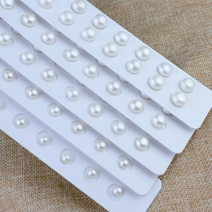 Macro view of assorted natural freshwater white pearls on display strips in multiple sizes