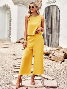 Detail of yellow two-piece summer set with sleeveless top and wide-leg cropped trousers
