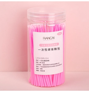 Macro detail of 100pcs pink lash micro brushes in a clear storage bottle for eyelash extension