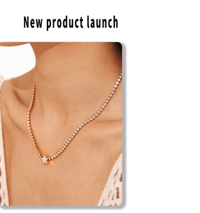 Close-up of gold star pendant necklace with cubic zirconia pavé on model's neck