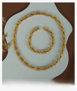 Detailed view of the gold-plated rectangular link necklace and bracelet jewelry set