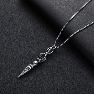 Vintage stainless steel vajra pestle pendant necklace with box chain on leather background