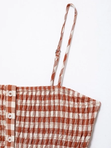Macro shot of brown checkered camisole with smocked fabric and adjustable strap details