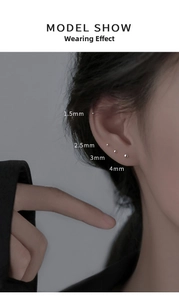 Close-up of four sizes 1.5mm to 4mm minimalist silver stud earrings on a model ear