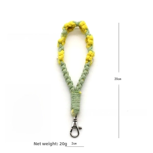 Detail of green and yellow hand-woven floral keychain with 20cm length measurement