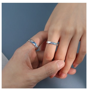 Detailed shot of Van Gogh Starry Night couple rings featuring blue enamel on silver