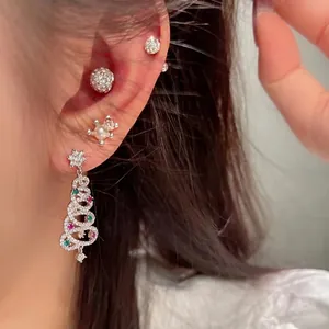 Festive S925 silver Christmas tree earrings with colorful zircon stones on woman ear