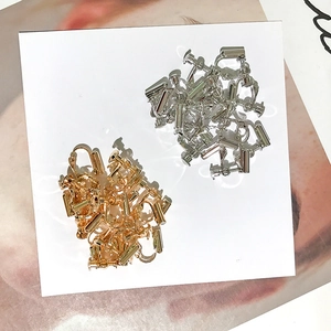 Adjustable gold and silver spiral earring converters displayed on a white card