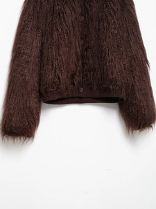 Close-up of deep brown faux fur cardigan featuring textured plush fabric and matching buttons