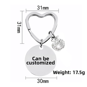 Silver heart keychain with a crystal-studded apple charm and a 30mm round engravable tag
