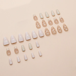 Set of 24 almond shaped press-on nails with heart bow designs and lace patterns