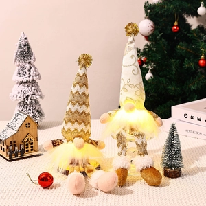 Close-up of glowing golden Christmas gnomes set against a cozy festive holiday backdrop