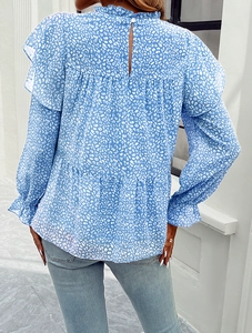 Detail of blue floral chiffon blouse showing ruffled collar and back button closure