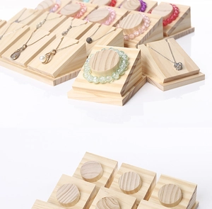 Detailed close-up of solid wood jewelry display stands for necklaces and bracelets